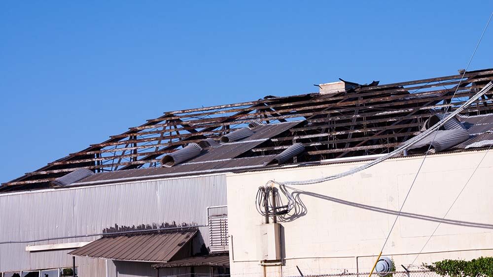 Commercial building roof damage after hurricane winds
