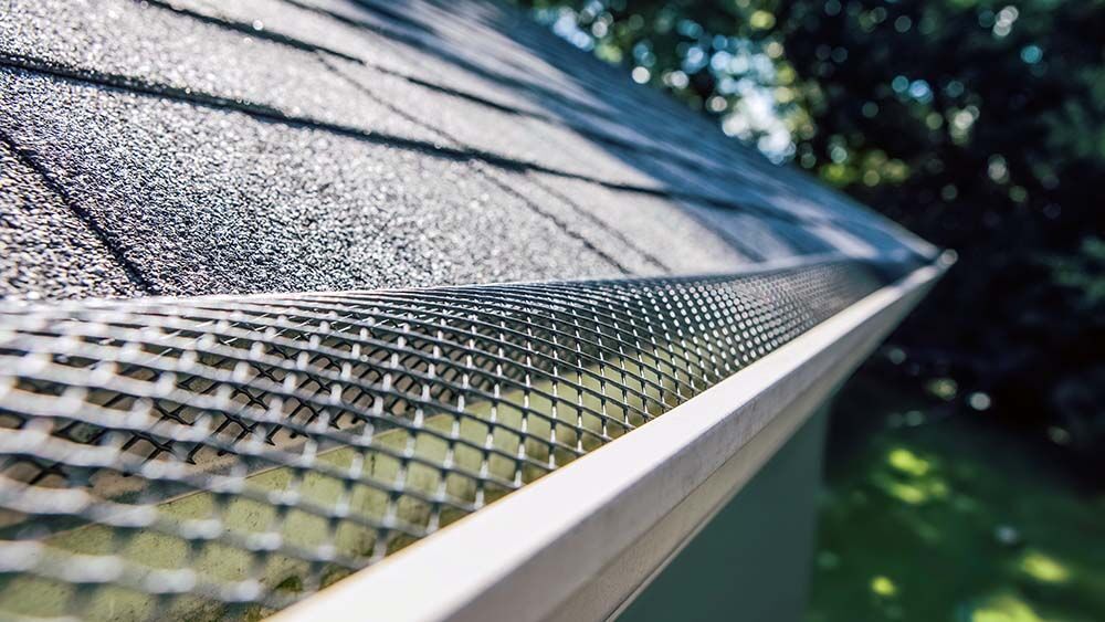 Gutter guard system protecting gutters from leaves and debris on an Atlanta home.