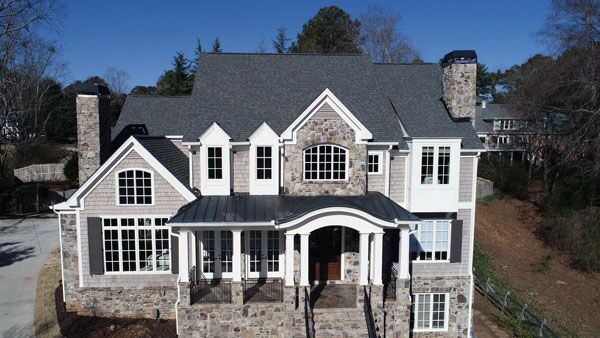Professional roof coating application on a residential home by KTM Roofing in Atlanta, GA.