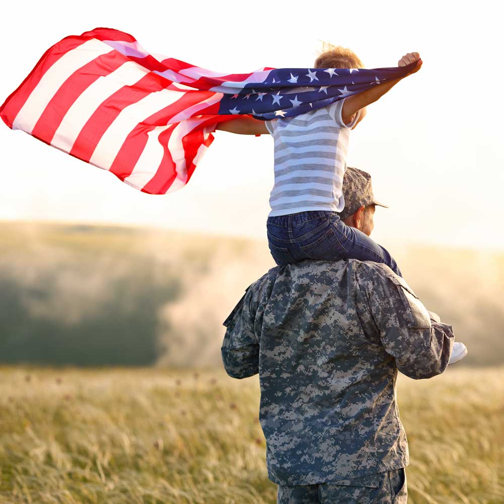 Dad with kid holding flag | KTM Roofing