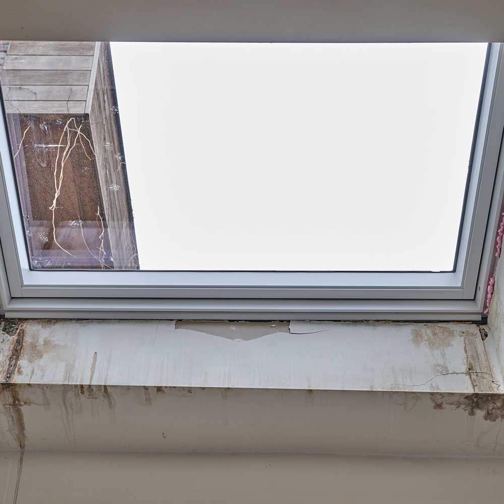 skylight-damage Damaged skylight with broken seal and water intrusion requiring replacement in Atlanta.