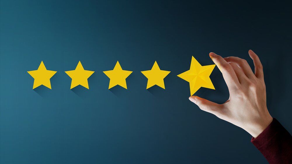 Hand Laying out Five Stars