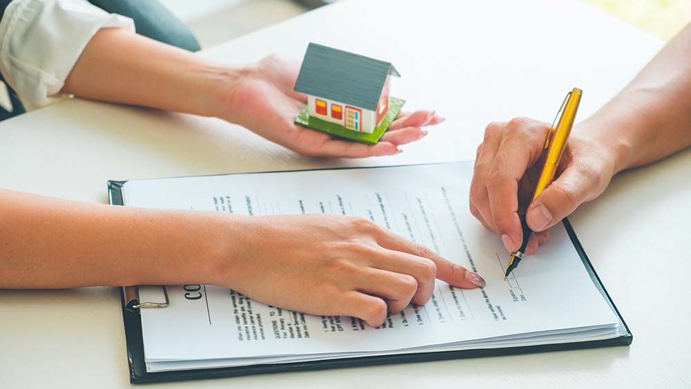 person signing document for house