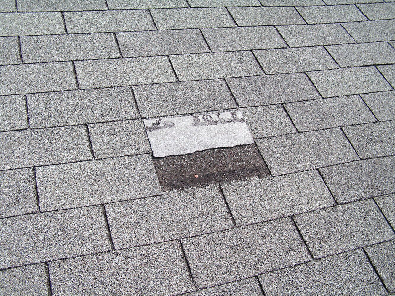 Shingle missing from a residential roof.