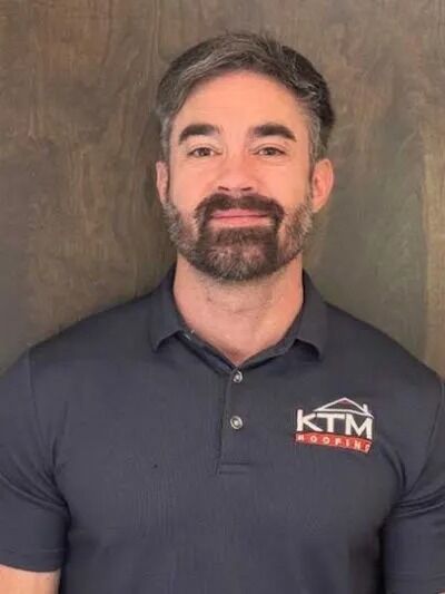Chris Tyson's KTM roofing headshot.