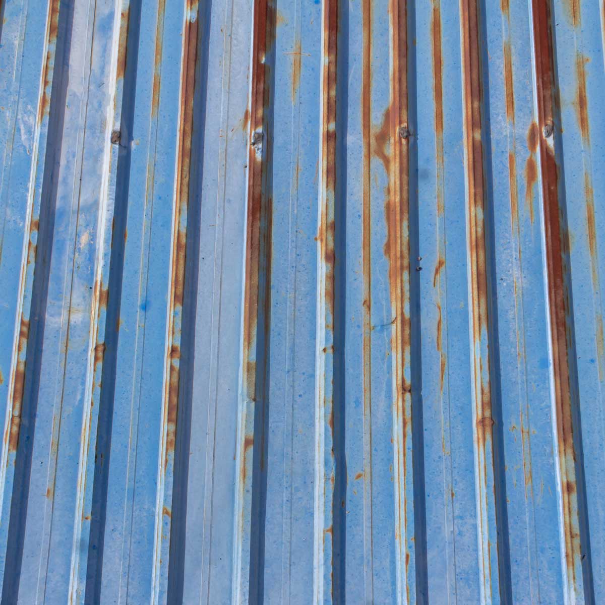 metal-roof-damage Metal roof panel with rust in need of metal roof repair.